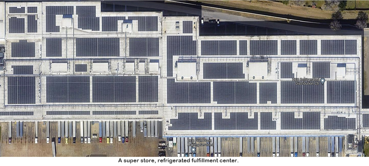 A supermarket refrigerated-products fulfillment center with approximately 100,000 panels on its roof. To get a sense of scale, notice the little “fringes” along the bottom of the building are tractor-trailers. (photo by DigitalMedia R&D)